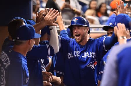 Aug 31, 2018; Miami, FL, USA; Toronto Blue Jays first baseman Justin Smoak (14) celebrates in the dugout after hitting the go ahead grand slam in the ninth inning against the Miami Marlins at Marlins Park. Mandatory Credit: Jasen Vinlove-USA TODAY Sports