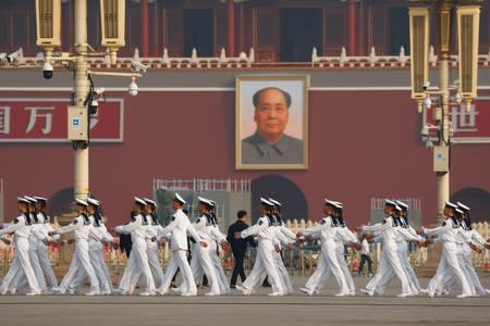 Soldiers march in Tiananmen Square before a wreath laying ceremony marking the 70th anniversary of the founding of the People's Republic of China in Beijing