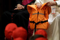 <p>Pope Francis holds a life vest as he meets with youths at the Vatican May 28, 2016. The life vest was used by a migrant who was found dead during a rescue on the Mediterranean sea. (REUTERS/Gregorio Borgia) </p>