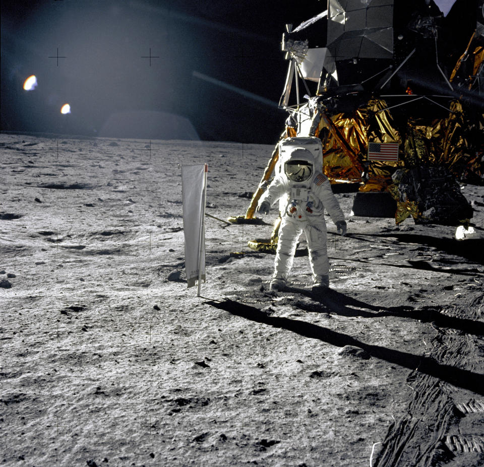 Astronaut Edwin E. Aldrin, Jr., Lunar Module pilot, is photographed during the Apollo 11 extravehicular activity (EVA) on the lunar surface on July 20, 1969. In the right background is the Lunar Module "Eagle." On Aldrin's right is the Solar Wind Composition (SWC) experiment already deployed. This photograph was taken by Neil A. Armstrong with a 70mm lunar surface camera. (Photo: NASA)