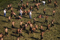 Wrestlers, doused in olive oil, perform the traditional stride on the arena prior to the second day of the 660th instalment of the annual Historic Kirkpinar Oil Wrestling championship, in Edirne, northwestern Turkey, Saturday, July 10, 2021.Thousands of Turkish wrestling fans flocked to the country's Greek border province to watch the championship of the sport that dates to the 14th century, after last year's contest was cancelled due to the coronavirus pandemic. The festival, one of the world's oldest wrestling events, was listed as an intangible cultural heritage event by UNESCO in 2010. (AP Photo/Emrah Gurel)