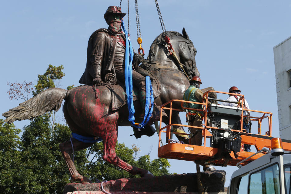 FILE - Crews prepare to remove a statue Confederate General J.E.B. Stuart on Monument Avenue in Richmond, Va. on July 7, 2020. At least 63 Confederate statues, monuments or markers have been removed from public land across the country since George Floyd’s death on May 25, making 2020 one of the busiest years yet for removals, according to an Associated Press tally. (AP Photo/Steve Helber, File)