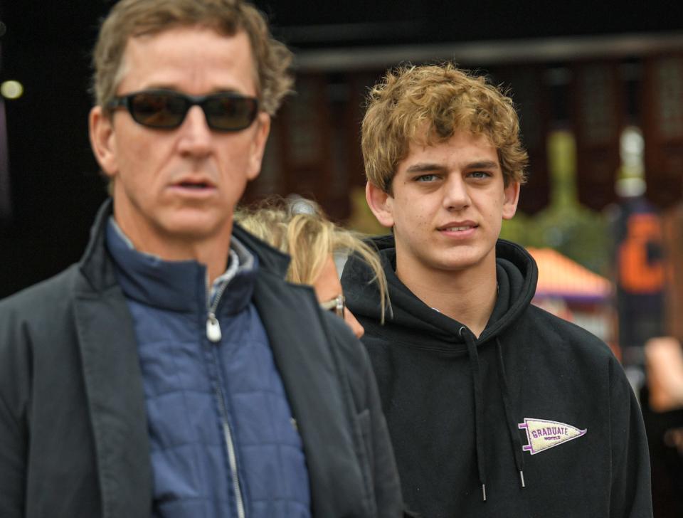 Prized quarterback recruit Arch Manning, right, and his father Cooper Manning are pictured before before Clemson's home game against Florida State at Memorial Stadium in October. Manning, a five-star recruit, will take an official visit to the University of Texas on June 18.