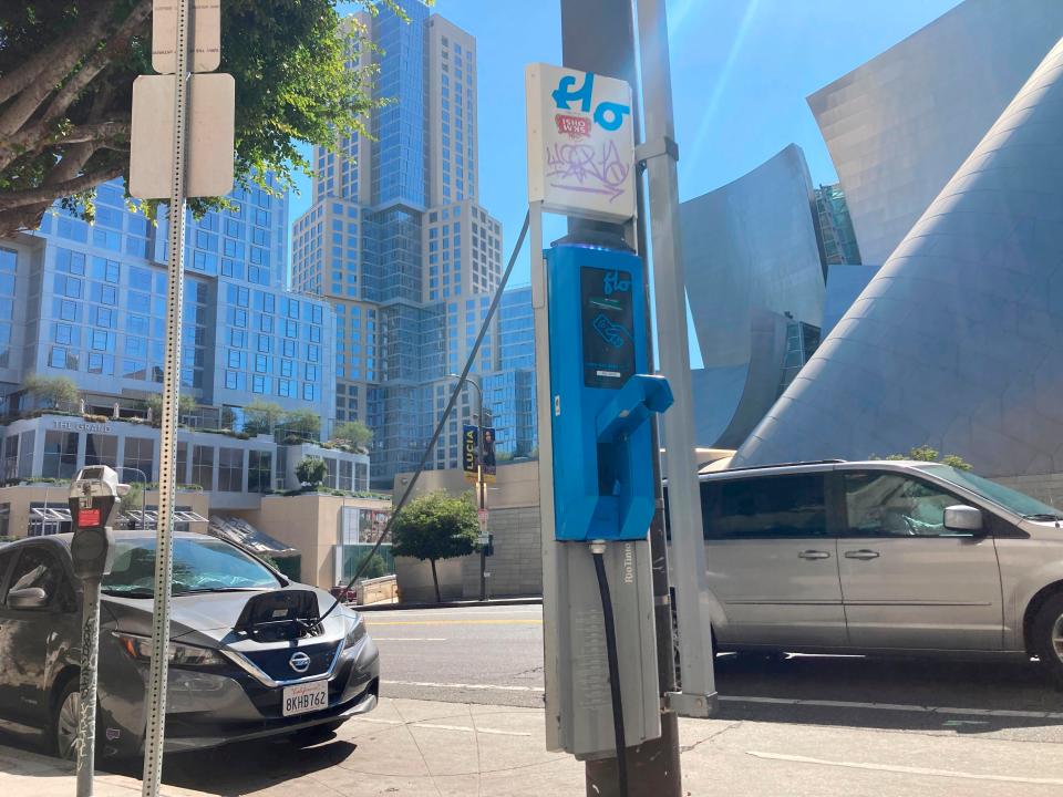 An electric vehicle charges on a publicly accessible pole-mounted charger in Los Angeles on Oct. 4, 2022. The second-largest electric vehicle fast-charging network, Electrify America, with 800 direct-current fast-charging stations and more than 3,600 plugs nationwide, said Wednesday, July 26, 2023, it will work to add Tesla's connector to existing and future chargers by 2025.