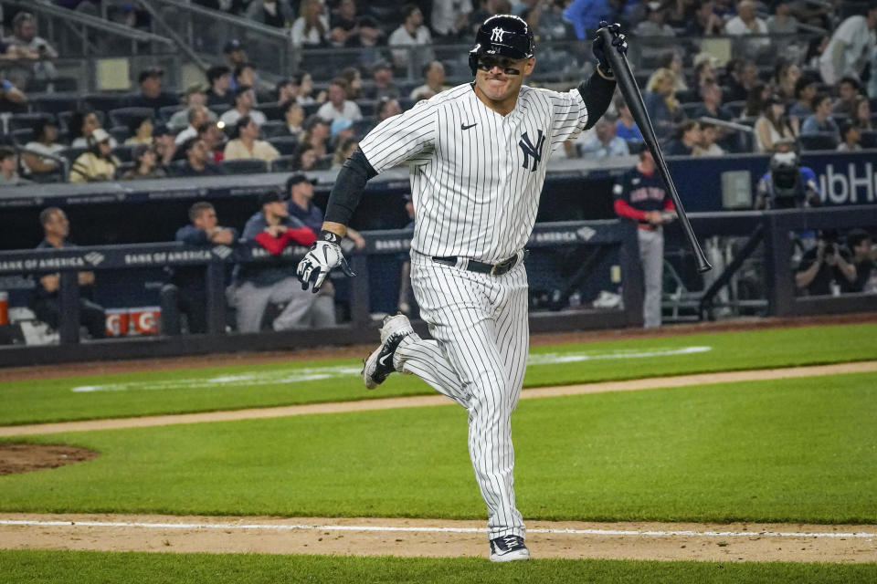 New York Yankees' Anthony Rizzo holds onto his bat as he runs towards first base after he flied out to center, during the eighth inning of a baseball game against the Boston Red Sox, Sunday, June 11, 2023, in New York. (AP Photo/Bebeto Matthews)