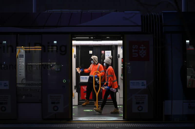 City workers sanitise the light rail at Circular Quay in Sydney