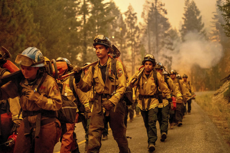 Cal Fire firefighters battle the Dixie Fire near Prattville in Plumas County, Calif., on Friday, July 23, 2021. (AP Photo/Noah Berger)