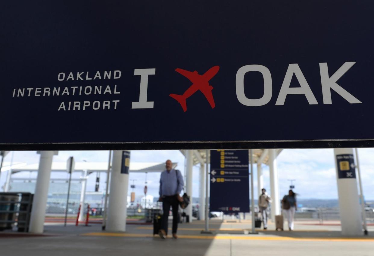 PHOTO: Travelers walk towards Terminal 2 at Oakland International Airport on April 12, 2024 in Oakland, Calif. (Justin Sullivan/Getty Images)