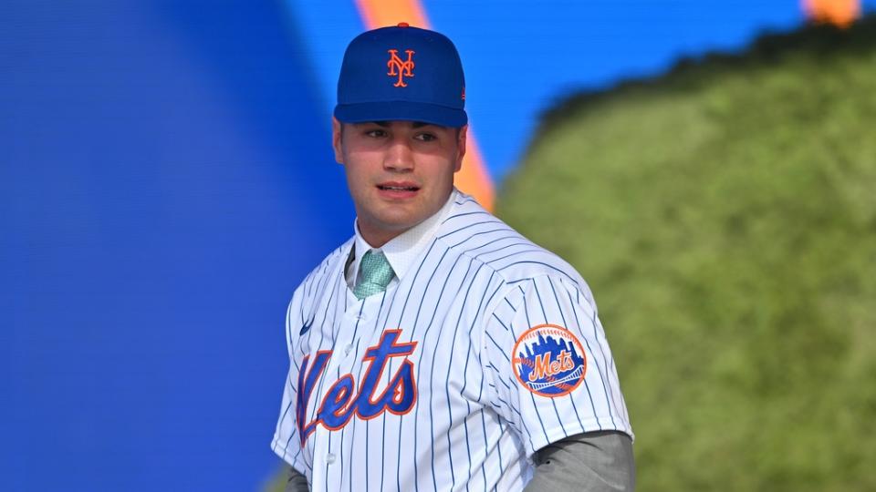 July 17, 2022;  Los Angeles, CA, USA;  Kevin Parada puts on a jersey after he was selected by the New York Mets as the 11th player in the MLB draft at XBox Plaza at LA Live.  Mandatory Credit: Jayne Kamin-Oncea-USA TODAY Sports