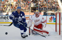 <p>The Leafs’ Leo Komarov and Wings goalie Jared Coreau. (Getty) </p>