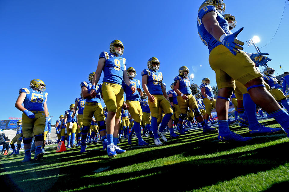 Nov. 15, 2020; Pasadena, California; UCLA Bruins quarterback Parker McQuarrie (9) leads players to the locker room after warming up for a game against the California Golden Bears at the Rose Bowl. Jayne Kamin-Oncea-USA TODAY Sports