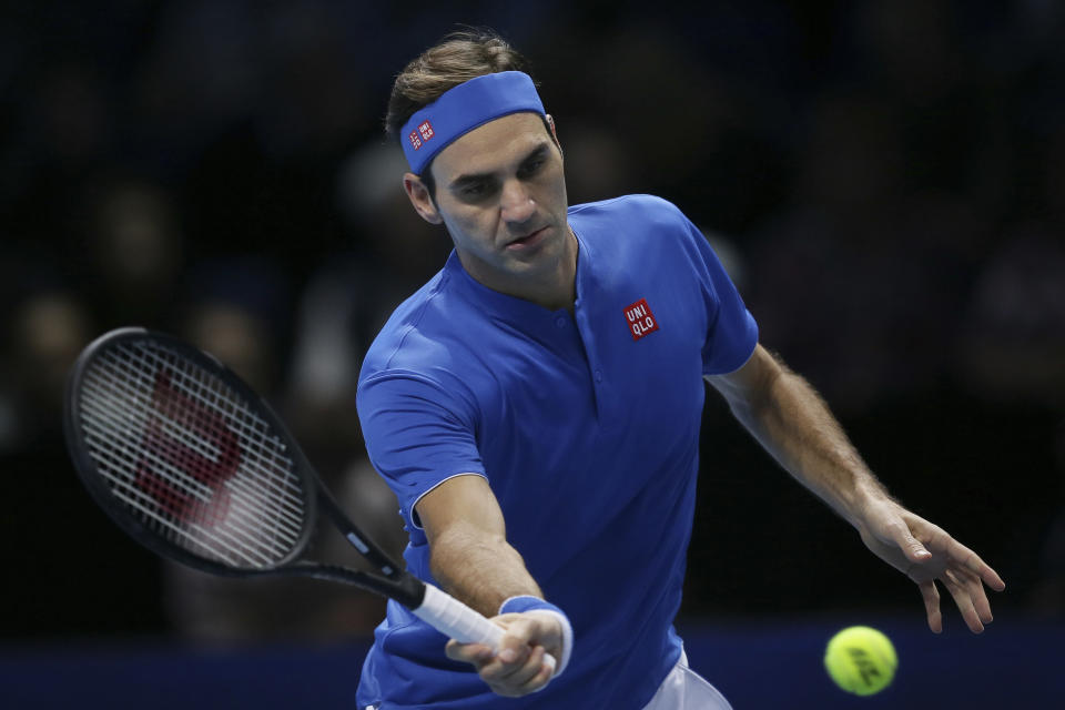 Roger Federer of Switzerland plays a return to Alexander Zverev of Germany in their ATP World Tour Finals singles tennis match at the O2 Arena in London, Saturday Nov. 17, 2018. (AP Photo/Tim Ireland)