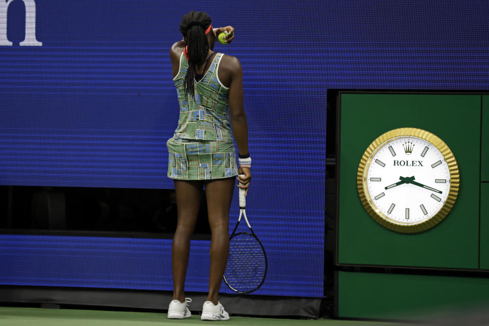 Coco Gauff wipes her face during a match against against Naomi Osaka, of Japan, in the third round of the U.S. Open tennis tournament Saturday, Aug. 31, 2019, in New York. (AP Photo/Adam Hunger)