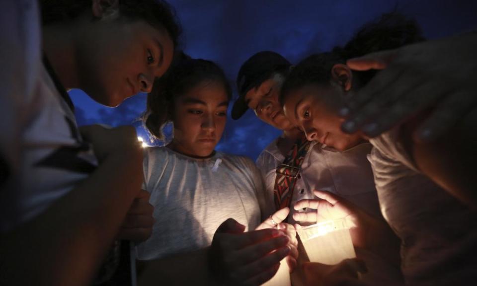 People gather in Juarez, Mexico, 3 August 2019, in a vigil for the Mexican nationals who were killed in an El Paso shopping-complex shooting.