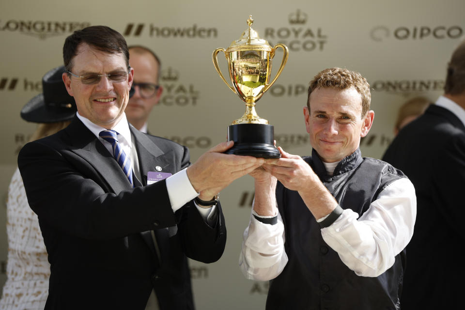 Horse Racing - Royal Ascot - Ascot Racecourse, Ascot, Britain - June 16, 2022  Ryan Moore and horse owner Aidan O'Brien celebrate with trophy after winning the 16:20 Gold Cup REUTERS/John Sibley