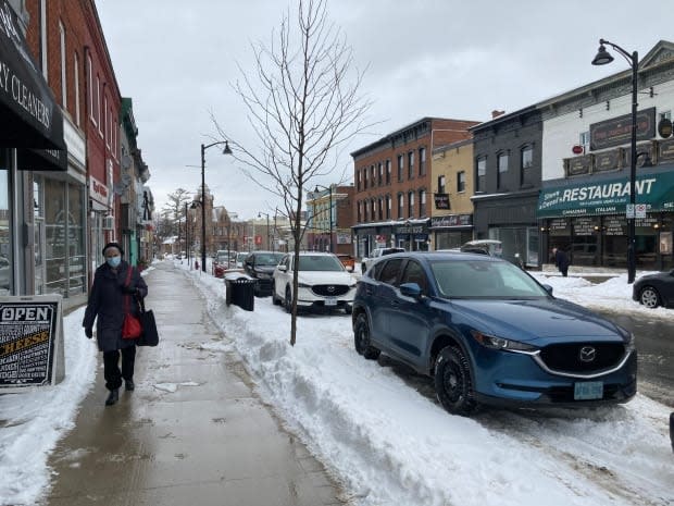 A woman in a mask walks through downtown Arnprior, Ont., on Feb. 27, 2021. The Renfrew County and District Health Unit will be moving into the yellow level on the province's pandemic scale starting after midnight March 8. (Remi Authier/Radio-Canada - image credit)