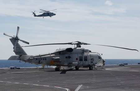 Japan Maritime Self-Defense Force (JMSDF) SH-60 Seahawk helicopters are seen on JMSDF's helicopter carrier Izumo as they take part in a military exercise in South China Sea, near Singapore, June 21, 2017. REUTERS/Nobuhiro Kubo