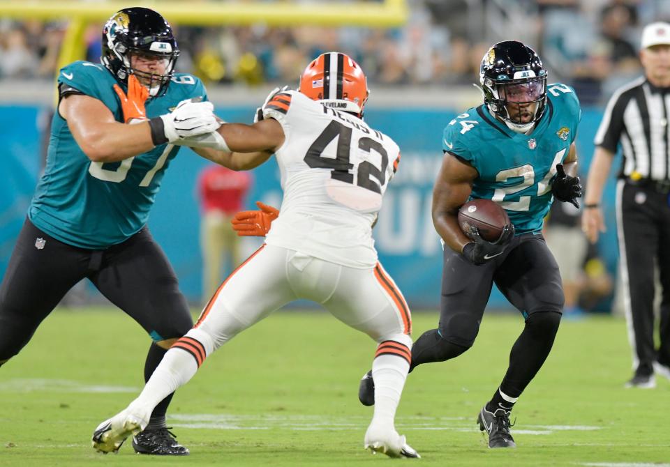 Jacksonville Jaguars guard Wes Martin (67) holds off Cleveland Browns linebacker Tony Fields II (42) to create a hole room for running back Snoop Conner (24) during a late second quarter pass play for 5 yards. The Jacksonville Jaguars hosted the Cleveland Browns at TIAA Bank Field in Jacksonville, Florida Friday, August 12, 2022 for the first home preseason game of the season. [Bob Self/Florida Times-Union]