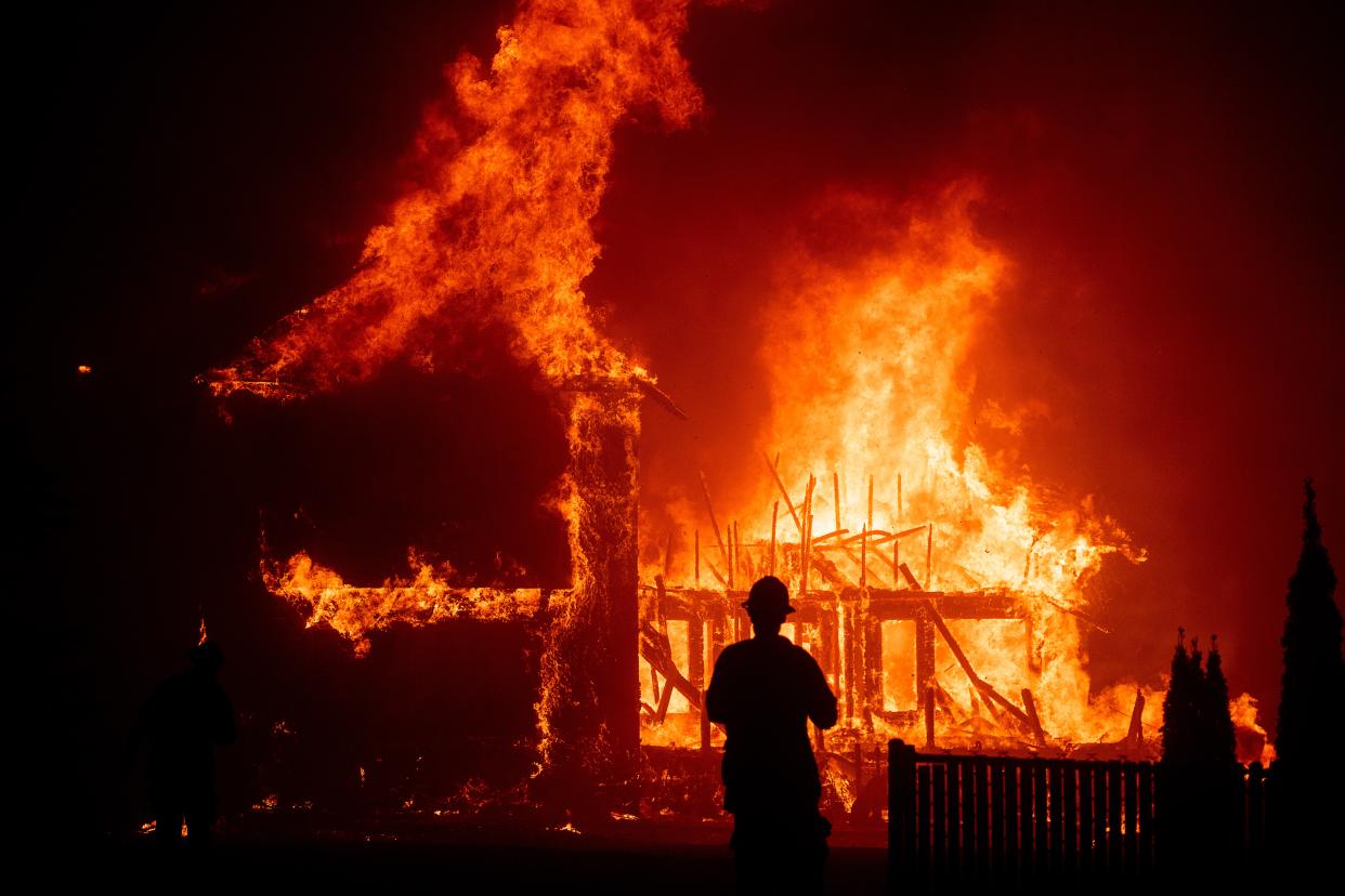 A home burns as the Camp Fire rages through Paradise, California on Thursday, November 8, 2018 (Noah Berger)