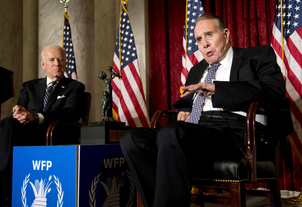 FILE - Former Senate Majority Leader Bob Dole, right, speaks after being presented with the McGovern-Dole Leadership Award by Vice President Joe Biden, left, to honor his leadership in the fight against hunger, during the 12th Annual George McGovern Leadership Award Ceremony hosted by World Food Program USA, on Capitol Hill in Washington, Dec. 11, 2013. (AP Photo/Manuel Balce Ceneta, File)