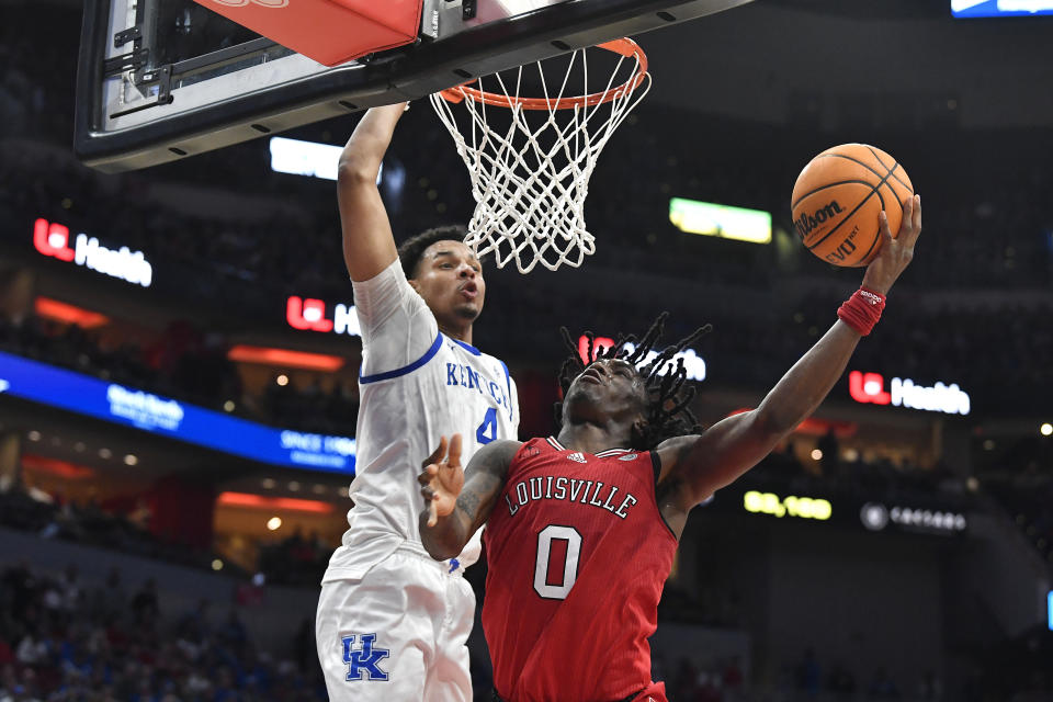 Louisville guard Mike James (0) shoots against Kentucky forward Tre Mitchell (4) during the second half of an NCAA college basketball game in Louisville, Ky., Thursday, Dec. 21, 2023. Kentucky won 95-76. (AP Photo/Timothy D. Easley)