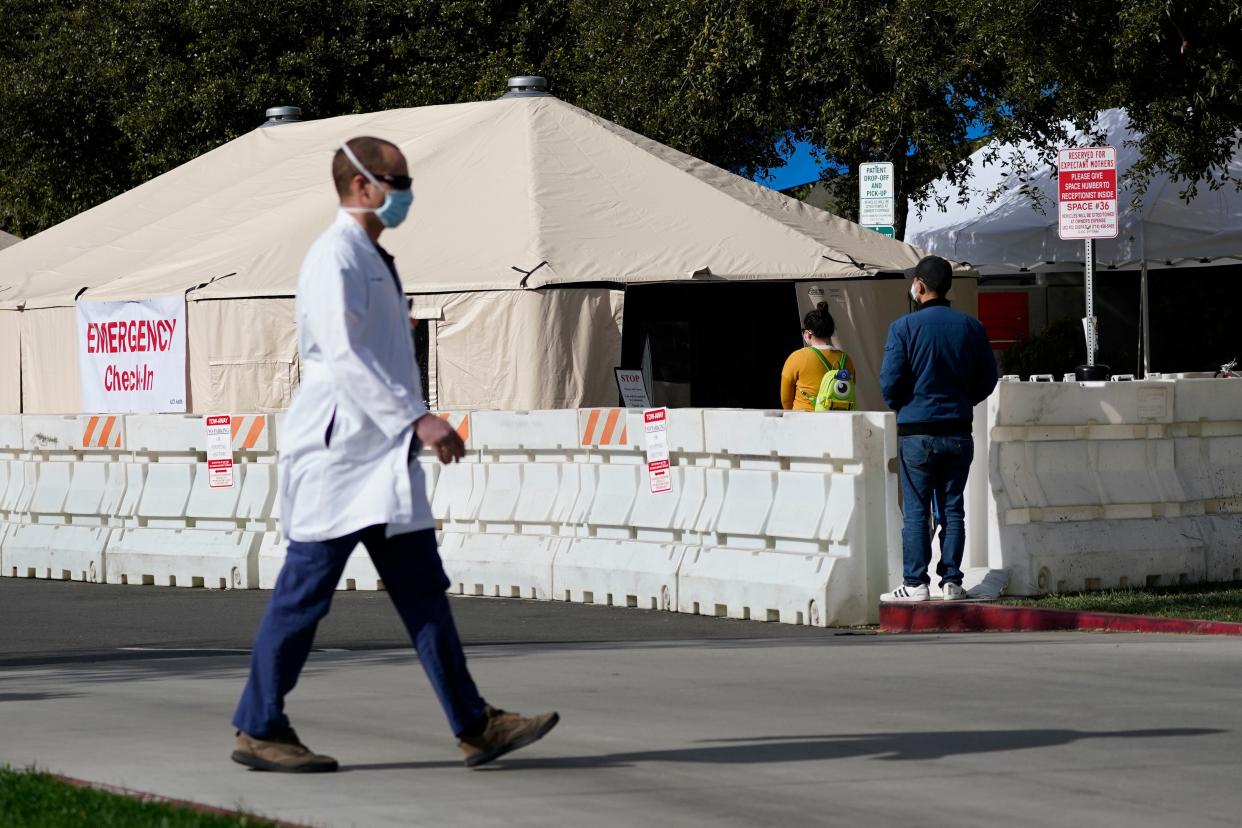 <p>A health worker passes a medical tent outside the emergency room at UCI Medical Center in Irvine, California on 17 December.</p> (AP)