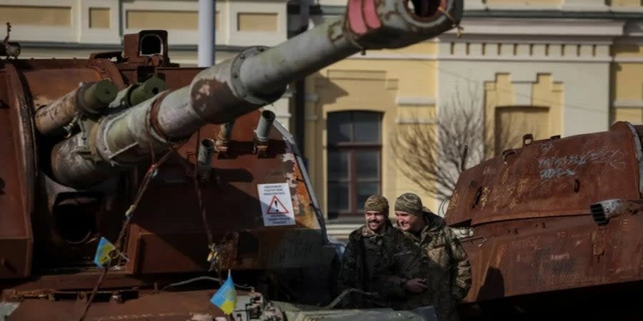 Ukrainian soldiers inspect destroyed Russian equipment in central Kyiv, Feb. 27