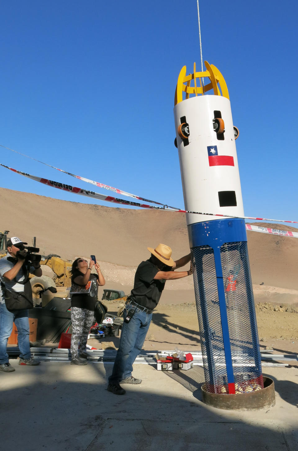 In this Feb. 11, 2014 photo, technicians test a human capsule on the set of the film "The 33" near Copiapo, Chile. The film dramatizes a cave-in that trapped 33 miners deep below Chile's Atacama desert for 69 days in 2010. Actors Juliette Binoche and Antonio Banderas are starring in the film based on the televised rescue that mesmerized millions of people around the globe. The movie is being shot in English and is expected to be released next year. (AP Photo/Eva Vergara)