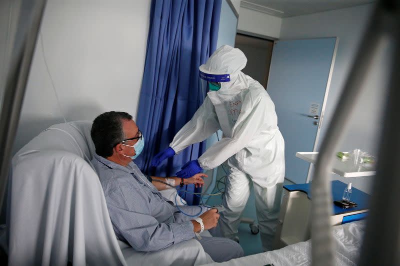 A nurse checks a patient in the COVID-19 ward of Cascais Hospital amid the coronavirus disease (COVID-19) pandemic in Cascais