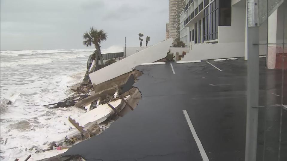 Waves pound the beach near a Daytona Shores hotel causing parts of the wall to collapse