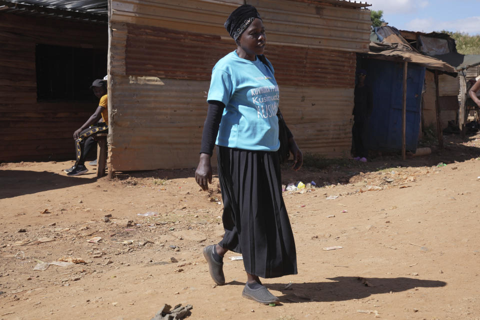 Siridzayi Dzukwa, a grandmother is seen walking to a home visit in Hatfcliffe on the outskirts of the capital Harare, Zimbabwe, Wednesday, May 15, 2024. In Zimbabwe, talk therapy involving park benches and a network of grandmothers has become a saving grace for people with mental health issues. Now the concept is being adopted in parts of the United States and elsewhere. (AP Photo/Tsvangirayi Mukwazhi)