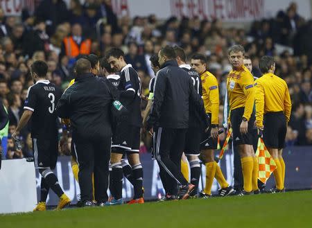 Players and officials leave the pitch due to several pitch invasions by spectators during the Europa League soccer match between Tottenham Hotspur and Partizan Belgrade at White Hart Lane in London November 27, 2014. REUTERS/Eddie Keogh