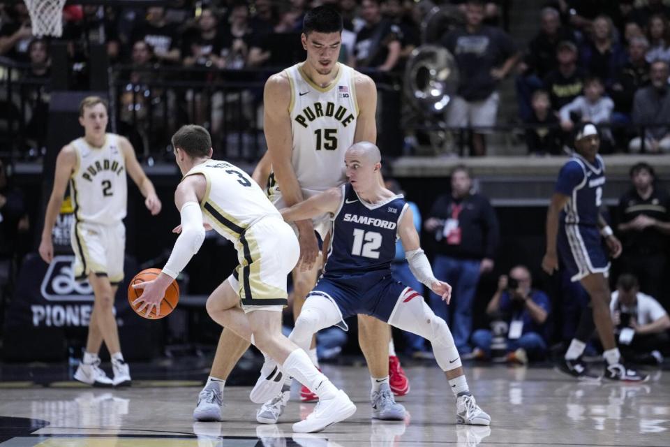 FILE - Purdue center Zach Edey (15) sets a pick for guard Braden Smith, left, on Samford guard Dallas Graziani.