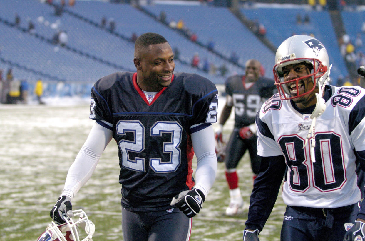Buffalo Bills defensive back Troy Vincent (23) and  New England Patriots wide receiver Troy Brown (80) walk off the field together after at Ralph Wilson Stadium in Orchard Park, New York on December 11, 2005. New England won the game 35-7. (Photo by Mark Konezny/Getty Images)