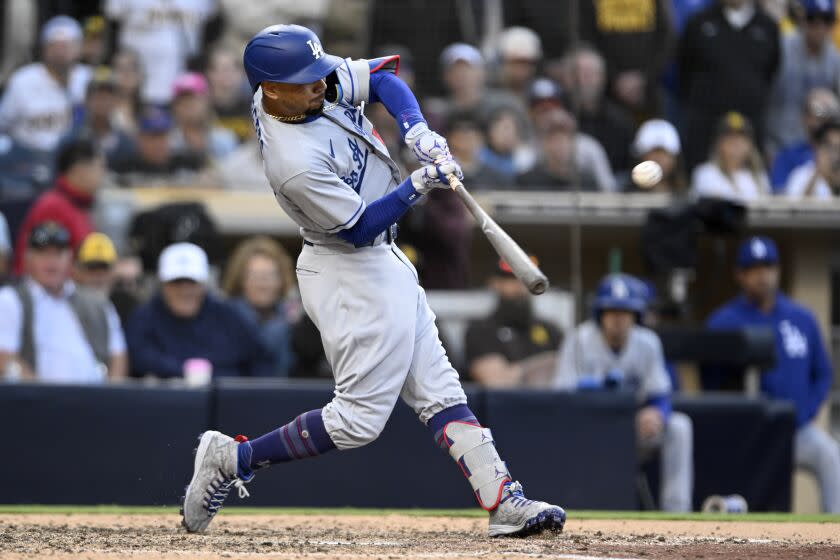 Los Angeles Dodgers' Mookie Betts hits a solo home run against the San Diego Padres.