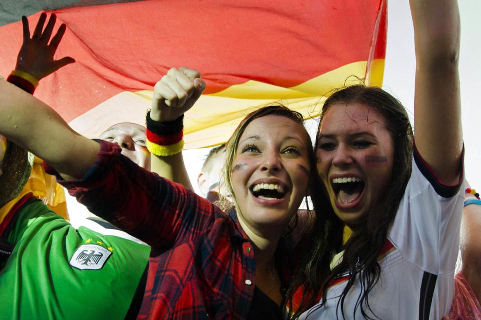 German fans celebrate as their team scores against the U.S. during their 2014 World Cup Group G soccer match, at the Fanmeile public viewing arena in Berlin June 26, 2014. REUTERS/Thomas Peter (GERMANY - Tags: SPORT SOCCER WORLD CUP)