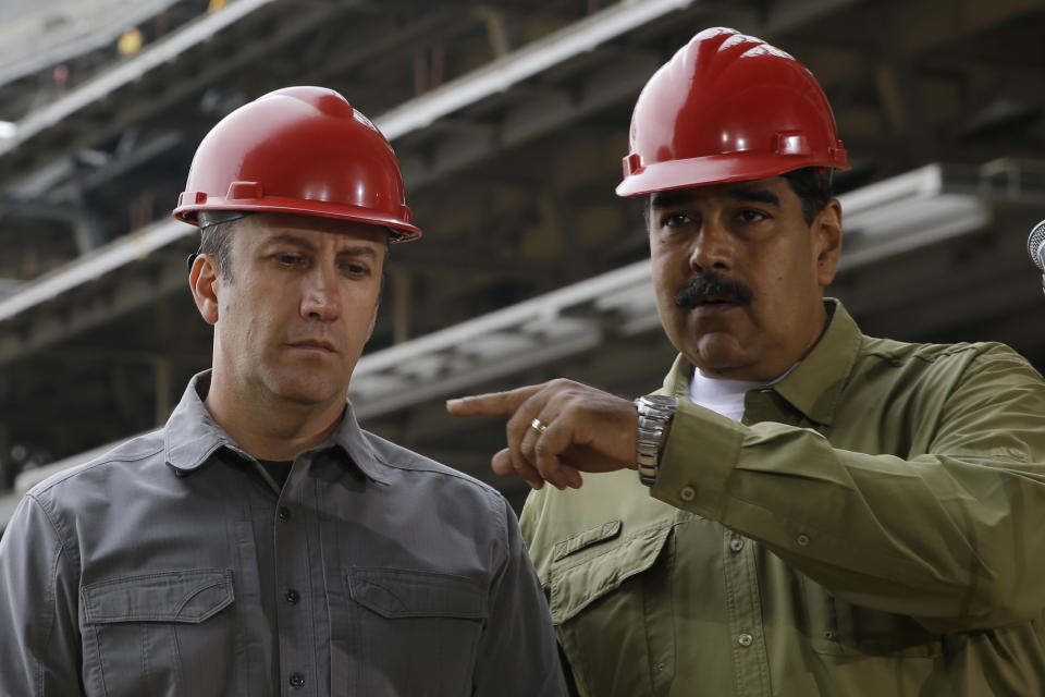 FILE - In this May 19, 2018 file photo, Venezuela's President Nicolas Maduro, right, and Vice President Tareck El Aissami tour La Rinconada baseball stadium that is under construction on the outskirts of Caracas, Venezuela. Maduro tasked El Aissami, who later became Venezuela's Oil Minister, with restructuring their nation's oil giant PDVSA in February 2020. (AP Photo/Ricardo Mazalan, File)