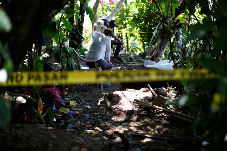 Silvana Turner of Argentine Forensic Anthropology Team (EAAF) watches forensic workers at an exhumation site in the village of Yancolo, as the team searches for human remains of the El Mozote massacre in the town of Cacaopera