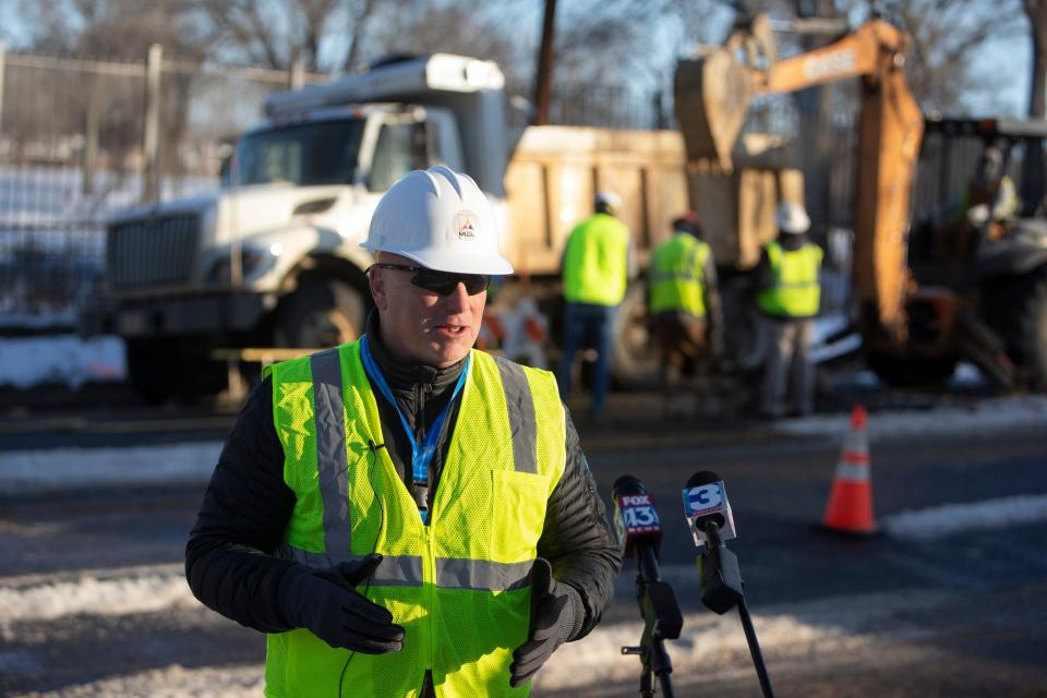 Doug McGowen, president and CEO of Memphis Light, Gas and Water, speaks to the media as a MLGW crew fixes a leak behind him in Memphis, Tenn., on Saturday, January 20, 2024.