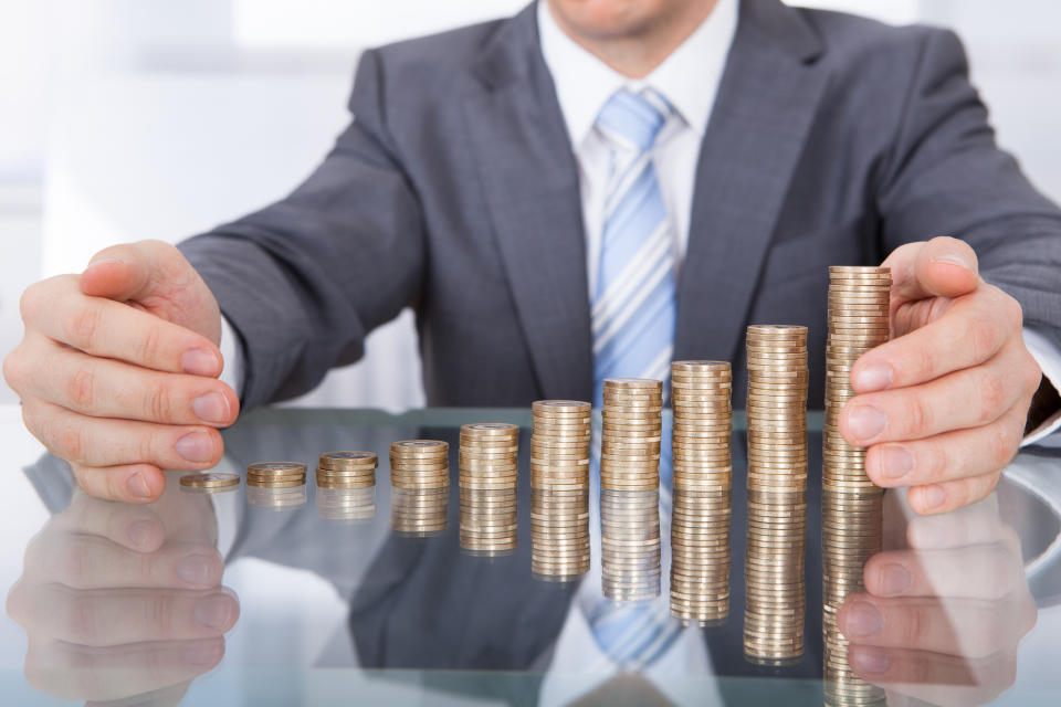 Businessman with stacks of coins