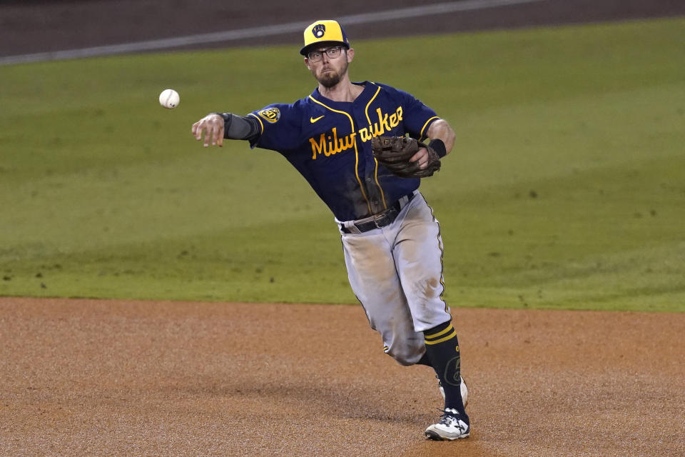 FILE - In this Sept. 30, 2020, file photo, Milwaukee Brewers third baseman Eric Sogard throws to first base during Game 1 of a National League wild-card baseball series in Los Angeles. The Brewers have declined 2021 options on infielders Jedd Gyorko and Eric Sogard as well as outfielder Ben Gamel. (AP Photo/Ashley Landis, File)