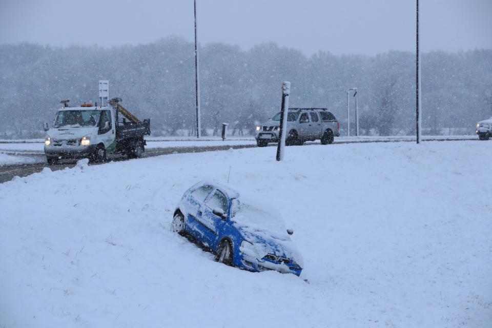 A car came off the road in snow in Bedale, North Yorkshire, on Monday: PA