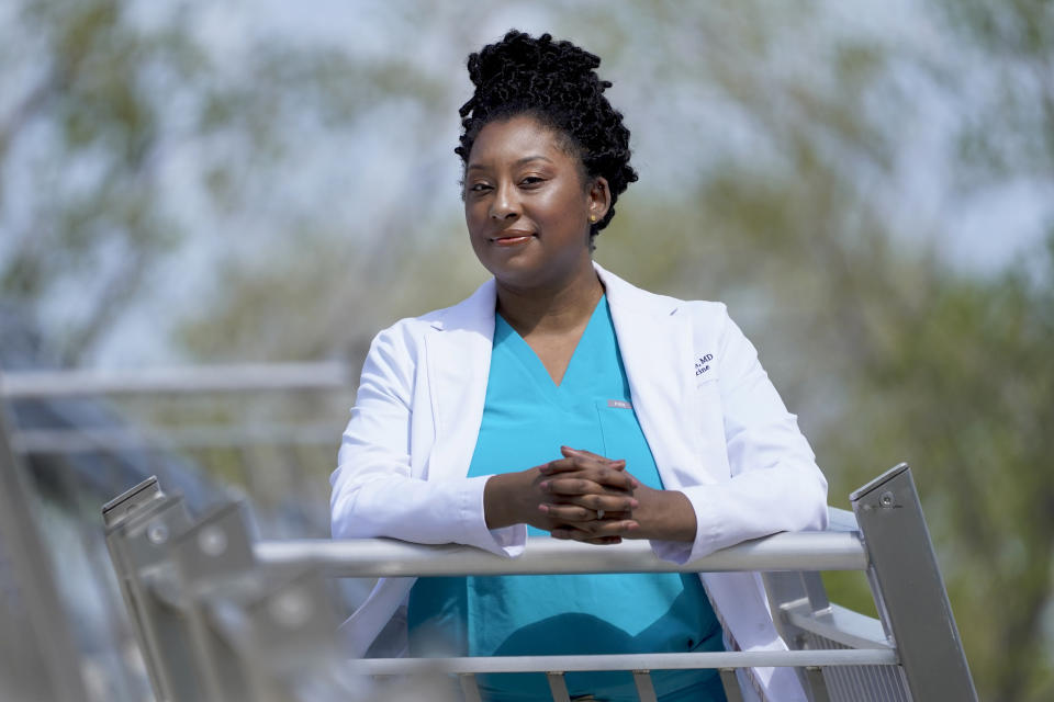 Dr. Brittani James poses for a portrait in the Bronzeville neighborhood of Chicago, Sunday, May 2, 2021. James and her twin, Dr. Brandi Jackson, have taken on the medical establishment in pioneering work to eliminate racism in medicine. (AP Photo/Charles Rex Arbogast)