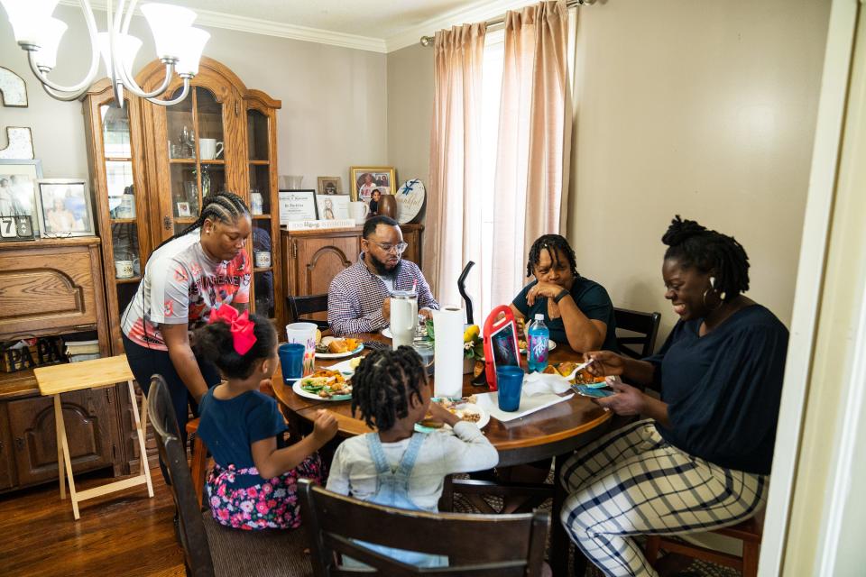 Pastor Tom Collins' family enjoys a meal together in his home in after church on Sunday.