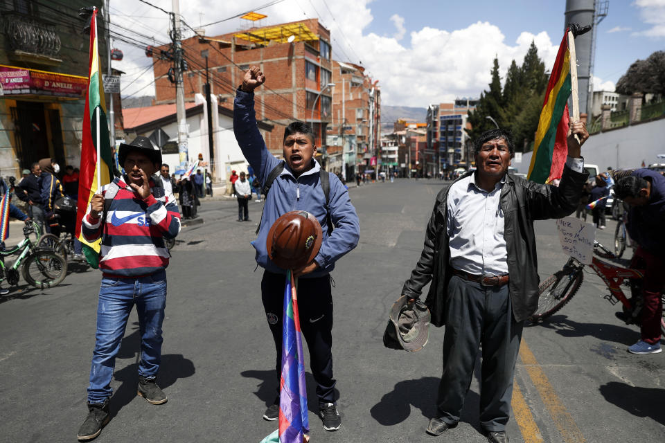 Anti-government demonstrators chant during a funeral procession for people killed in clashes between supporters of former President Evo Morales and security forces, in La Paz, Bolivia, Thursday, Nov. 21, 2019. At least eight people were killed Tuesday when security forces cleared a blockade of a fuel plant by Morales's backers in the city of El Alto. (AP Photo/Natacha Pisarenko)