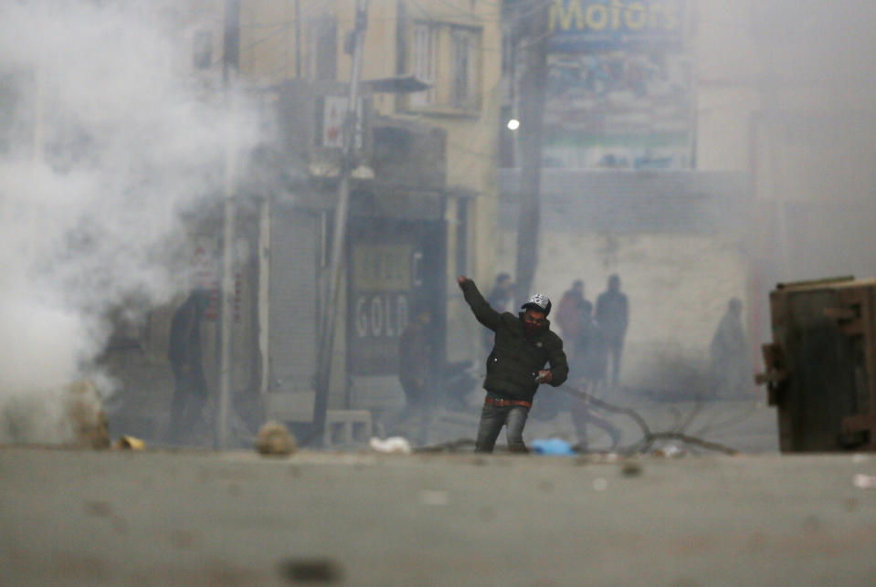 Kashmiri protesters clash with Indian paramilitary soldiers in Srinagar, Indian controlled Kashmir, Sunday, Dec. 16, 2018. A security clampdown and a strike sponsored by separatists fighting against Indian rule shut most of Indian-administered Kashmir on Sunday, a day after chaotic protests and fighting killed seven civilians and four combatants in the disputed region. (AP Photo/Mukhtar Khan)