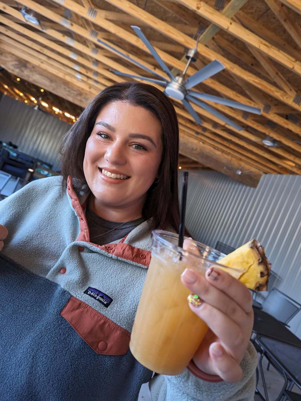 Lexie Taylor Austin cheers with a signature cocktail at the third annual BCKC No-Yak event held at Creekside Good Food-Good Vibes on Saturday, Oct. 7, 2023.