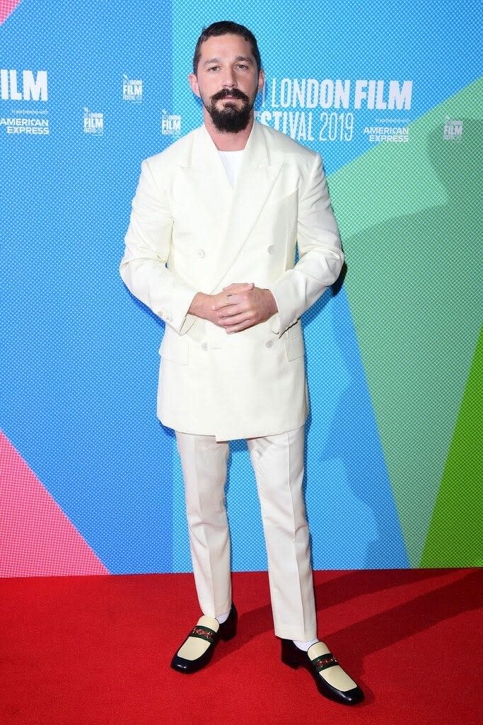 Shia LaBeouf in a white suit from the Spring 2020 show, with a regal, oversized jacket silhouette.