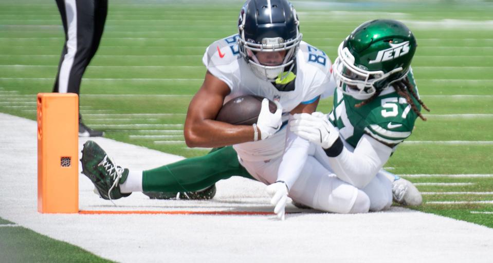 Tennessee Titans wide receiver Tyler Boyd (83) is tackled by New York Jets linebacker C.J. Mosley (57) during their game at Nissan Stadium in Nashville, Tenn., Sunday, Sept. 15, 2024.