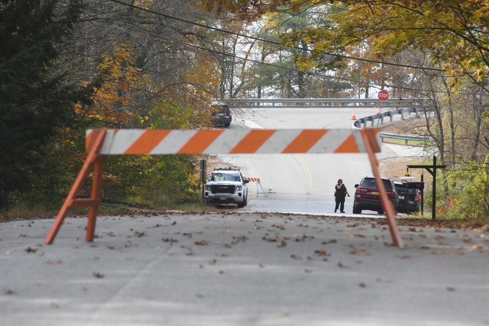 Law enforcement agents surround an area in Lisbon, Maine on Friday at the boat launch where Robert Card's vehicle was found after two mass shootings. Hundreds of law enforcement agents were scouring communities around Lewiston, Maine, for Card, an "armed and dangerous" suspect in killings at a bowling alley and a bar as residents sheltered in place in their homes.